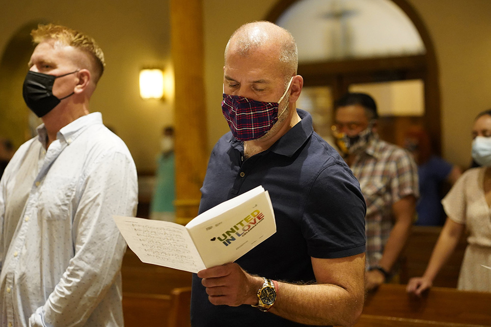 A worshiper sings during an annual "Pre-Pride Festive Mass" June 26, 2021, at St. Francis of Assisi Church in New York City. The liturgy, hosted by the parish's LGBT Ministry, is traditionally celebrated on the eve of the city's Pride march for the LGBTQ+ community. (CNS/Gregory A. Shemitz)