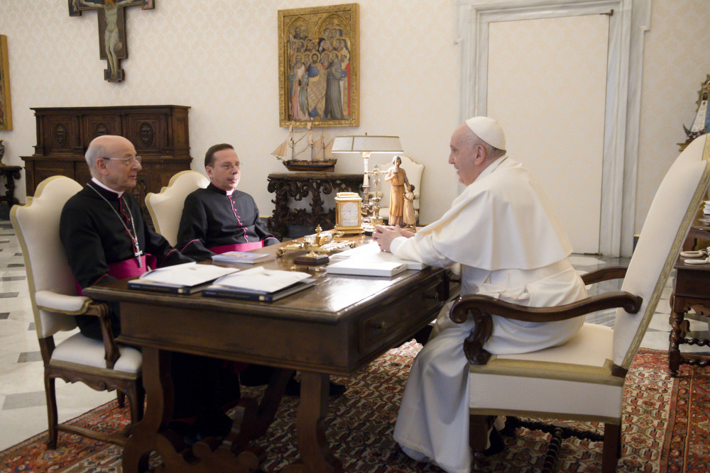 Pope Francis meets Msgr. Fernando Ocáriz, left, the prelate of Opus Dei, and Msgr. Mariano Fazio, the auxiliary vicar of the prelature, during an audience at the Vatican Nov. 29, 2021. (CNS photo/Vatican Media)