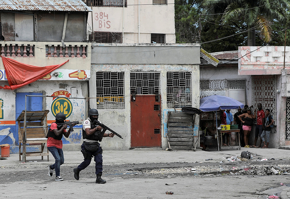 Police officers hold their position as they take part in an anti-gang operation amid gang violence March 3 in Port-au-Prince, Haiti. U.N. human rights expert William O'Neill, who was appointed to assess the situation in Haiti in April, told reporters June 28 that a "specialized international force" is needed to help fight gang violence ravaging the impoverished Caribbean nation. (OSV News/Reuters/Ralph Tedy Erol)