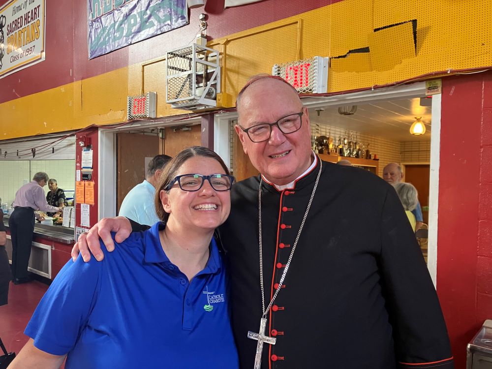 Cardinal Timothy M. Dolan of New York greets Shannon Kelly, CEO of Catholic Charities of Orange, Sullivan and Ulster counties, after celebrating Mass at Sacred Heart of Jesus Church in Highland Falls July 22, 2023. A steady army of volunteers and Catholic Charities have been working with the parish to provide aid to residents affected by a July 9 storm that devastated local communities in the Mid-Hudson Valley. (OSV News/The Good Newsroom/Beth Griffin)