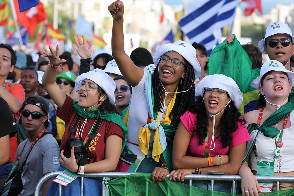 Pilgrims cheer prior to the opening Mass for World Youth Day at Eduardo VII Park in Lisbon, Portugal, Aug. 1, 2023. (OSV News/Bob Roller)