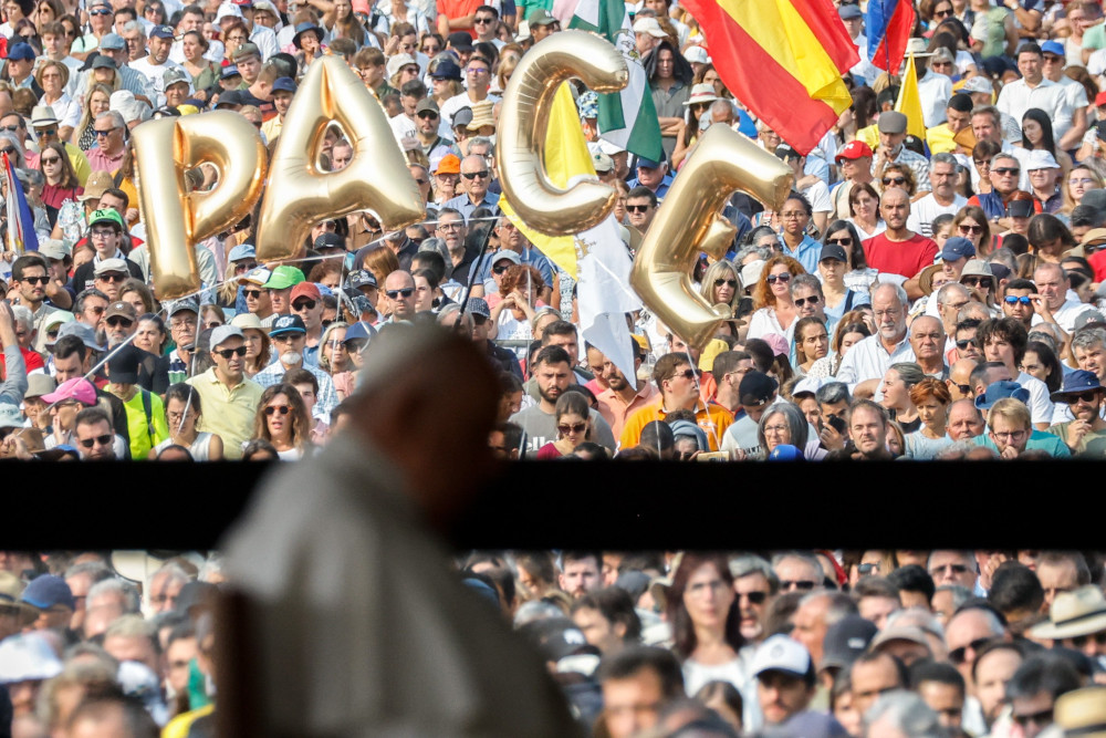 The word "PACE," peace, is seen in the crowd gathered as Pope Francis recites the rosary with young people who are ill at the Chapel of Apparitions at the Shrine of Our Lady of Fátima in Fátima, Portugal, Aug. 5, 2023. (CNS photo/Lola Gomez)