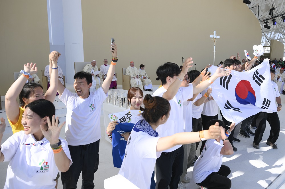 Young South Koreans cheer after Pope Francis announces that the next World Youth Day will take place in 2027 in Seoul. The pope made the announcement after the closing Mass for World Youth Day at Tejo Park in Lisbon, Portugal, Aug. 6.