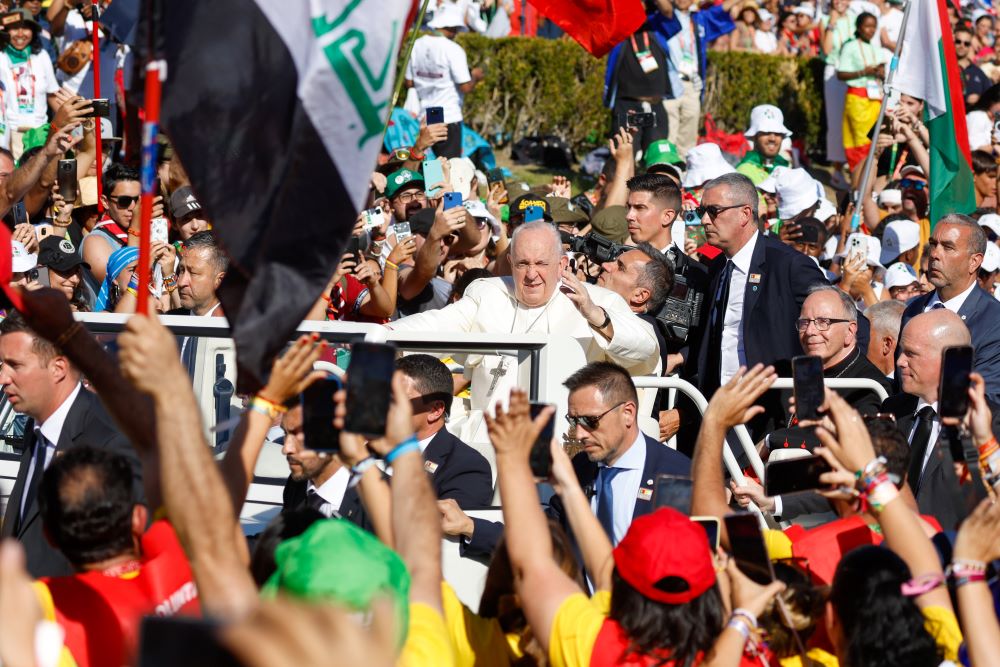 Young people cheer as Pope Francis arrives in the popemobile for the World Youth Day Stations of the Cross with young people at Eduardo VII Park in Lisbon, Portugal, Aug. 4. (CNS/Lola Gomez)