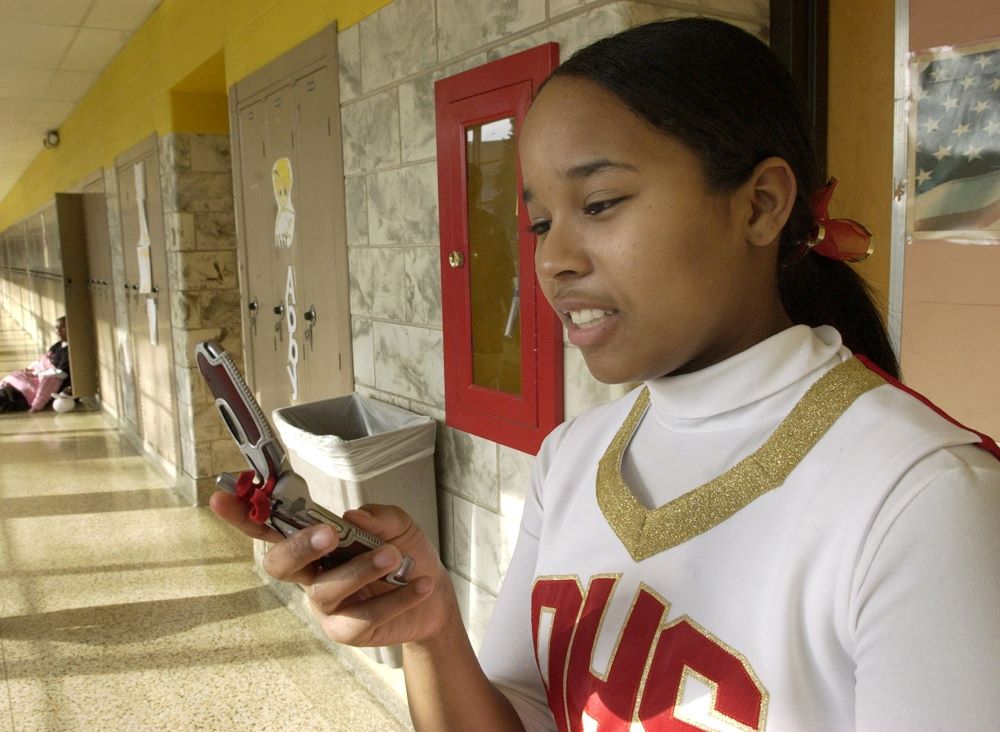 Candi Daniels, a junior at Andrean High School, Merrillville Indiana., tries to reach her parents after school before cheering at a basketball game in this Feb. 24, 2006, file photo. (CNS/Karen Callaway)