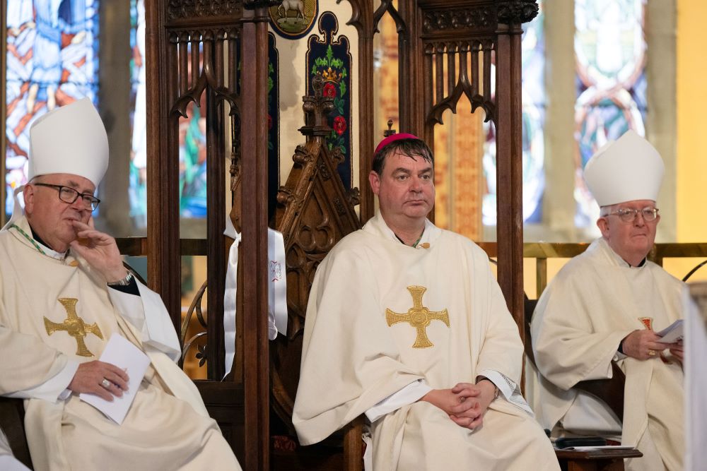 Bishop Stephen Wright of the Hexham and Newcastle Diocese, center, sits during his installation ceremony July 19.