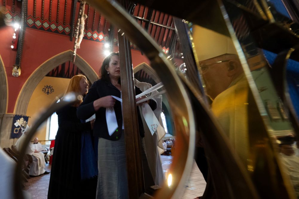 Members of Forcefence, which advocates for clergy abuse survivors, tie ribbons to the Bishop Stephen Wright's episcopal chair.