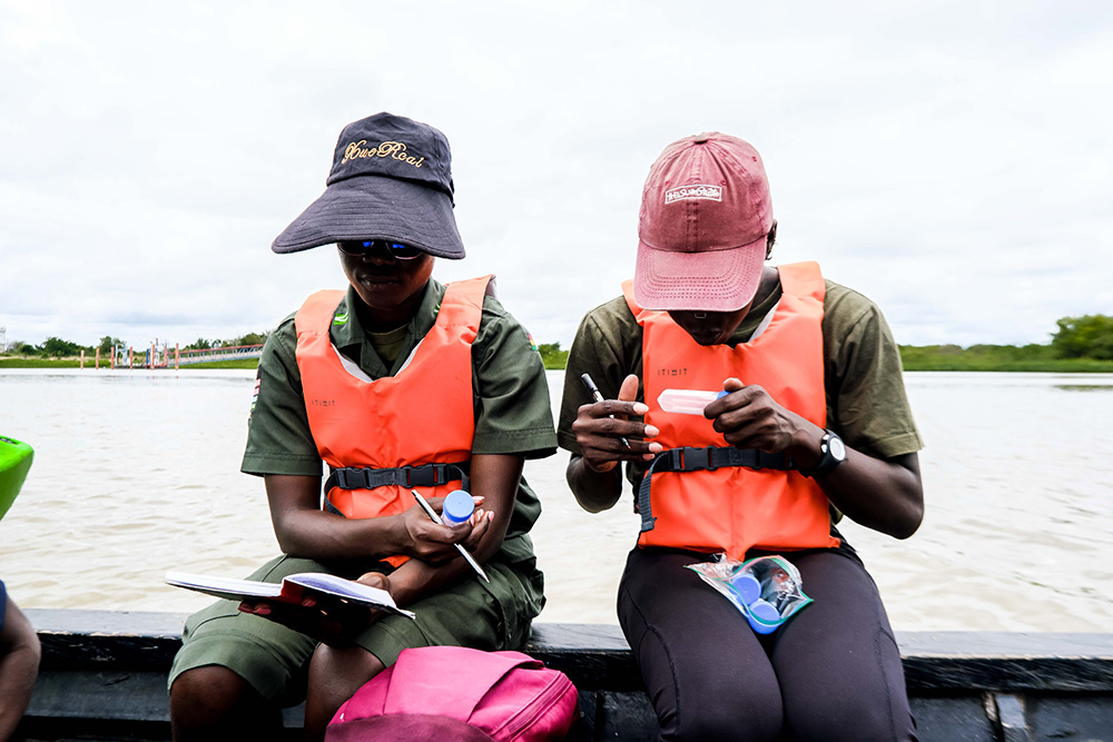 Agbetsi Living Water Swim expedition crew members note down sampling data. (Courtesy of the Or Foundation)