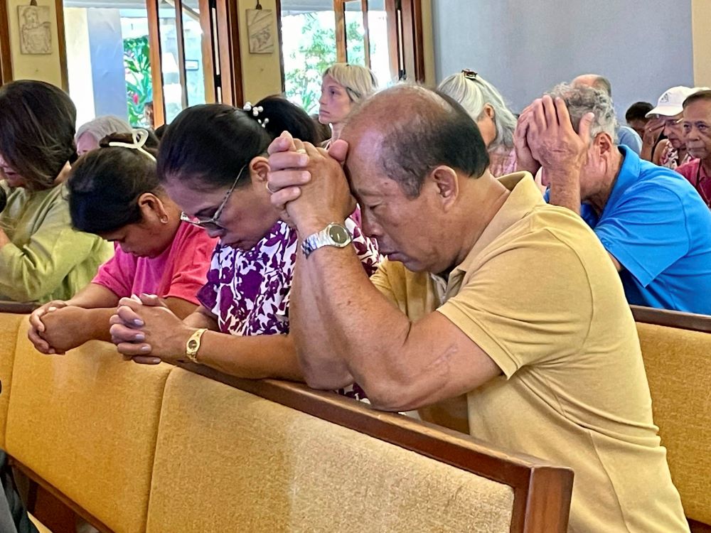 Parishioners attend Mass at Sacred Hearts Mission Church in Kapalua, Hawaii, Sunday, Aug. 13, 2023.