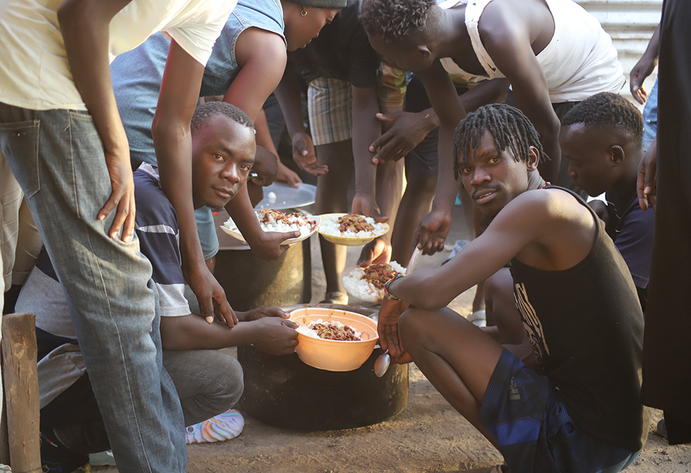 The LGBTQ refugees in Kakuma Refugee Camp share food on February 18. The LGBTQ refugees said that sometimes they are denied the normal food ratio that all the refugees get because of their sexual orientation and identity. (NCR photo/Doreen Ajiambo)