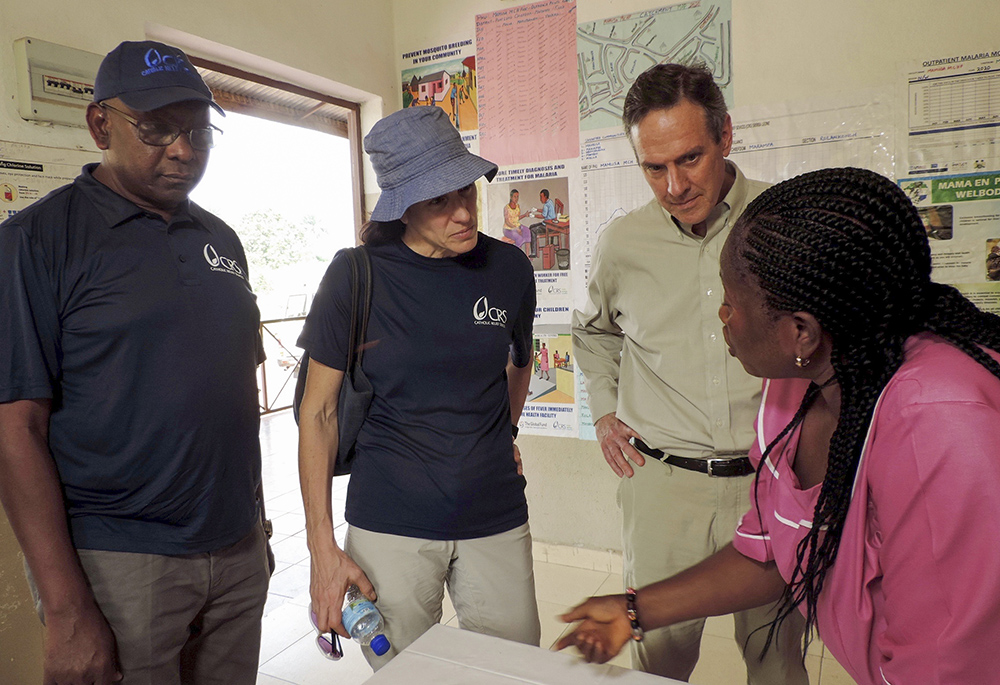 Jennifer Overton, West Africa regional director with Catholic Relief Services (second from left), stands with CRS president and CEO Sean Callahan during a visit to a health unit supported by CRS in Port Loko District Sierra Leone in 2020. (Courtesy of Catholic Relief Services)
