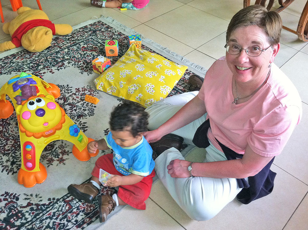 Sr. Maureen Geary sits with a child in an orphanage run by the Grand Rapids Dominicans in 2014, part of a campus of ministries the sisters began in Chimbote, Peru. (Courtesy of Maureen Geary)