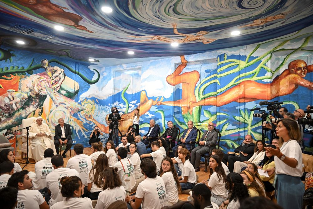 Pope Francis and Scholas Occurrentes' President Jose Maria del Corral, second from left, attend a meeting with members of the Scholas Occurrentes community of young people, an International educational movement created by Pope Francis himself, in Cascais, 25 kilometers south of Lisbon, Thursday, Aug. 3, 2023. (AP/Marco Bertorello)