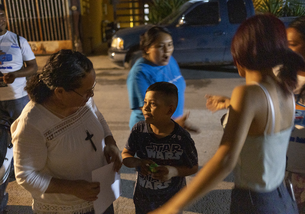 Sr. Sanjuana Morales Nájera, from left, and Sr. Sandra López García greet Eduardo López Sánchez, 8, and his aunt, Yolanda Martínez Hernández during a visit to their barrio in Monterrey, Mexico. The sisters and lay missionaries minister to youth gangs across the city on a weekly basis. (Nuri Vallbona)