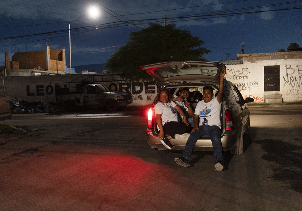 Missionaries Raquel Torres Gatica, from left, Víctor Edgar Hernández Rubio and Eusebio Leos Hernández pile into a car to go to the next location as they evangelize to chavos banda (youth gangs) on the streets of Monterrey, Mexico, in May. They go out weekly with Society of Mary of Nazareth sisters to minister to the youths. (Nuri Vallbona)