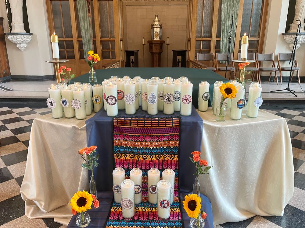 Tall candles on table in chapel