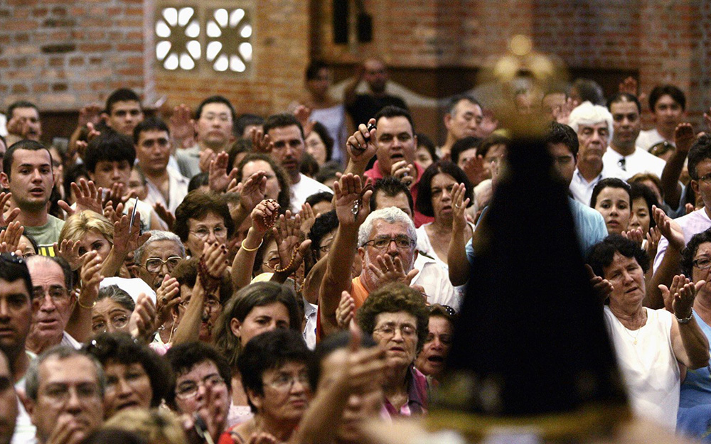 Catholics pray in the basilica Feb. 2, 2007, in Aparecida, Brazil. Before he became Pope Francis, Argentine Cardinal Jorge Bergoglio played a pivotal role in drafting the final document of CELAM's Fifth General Conference of Bishops of Latin America and the Caribbean, held in Aparecida, in May 2007. (CNS/Reuters/Paulo Whitaker)