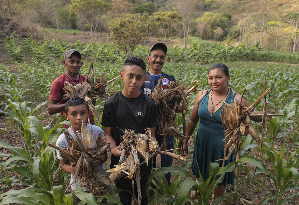 Portrait of the Figueroa Family: Maximiliano Turcios, 60, Mainor Alexis Figueroa, 9, Emilson Figueroa, 14, Rony Figueroa, 35, and Reina Padilla, 35, in their corn, bean and banana plantations that are watered even in the dry season thanks to the assistance of the RAICES-DRR Project. The family uses conservation agriculture practices from the Water-Smart Agriculture program from Catholic Relief Services. (OSV News photo/Oscar Leiva, Silverlight for Catholic Relief Services)