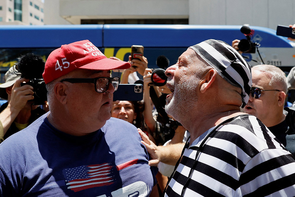 A supporter of former U.S. President Donald Trump and an anti-Trump demonstrator argue near the Wilkie D. Ferguson Jr. U.S. Courthouse, on the day Trump appeared for his arraignment on classified document charges, in Miami June 13. (OSV News/Reuters/Marco Bello)