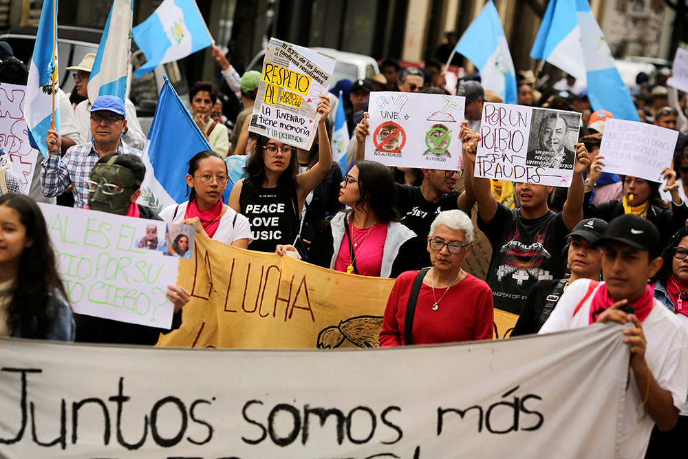 Supporters of presidential candidate Bernardo Arévalo of the Seed Movement party protest in Guatemala City July 13 outside the Guatemala attorney general's office to demand respect for the results of the first round of presidential elections. (OSV News/Reuters/Cristina Chiquin)