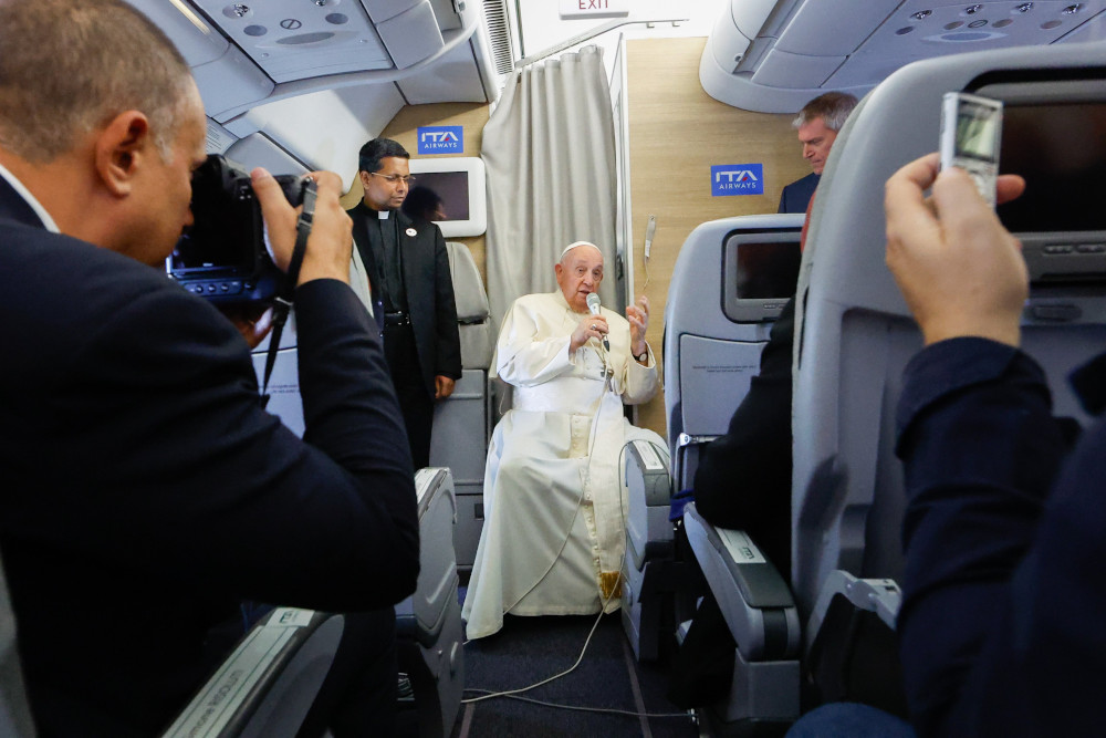 Pope Francis answers questions from journalists aboard his flight back to Rome from Ulaanbaatar, Mongolia, Sept. 4, 2023. (CNS photo/Lola Gomez)