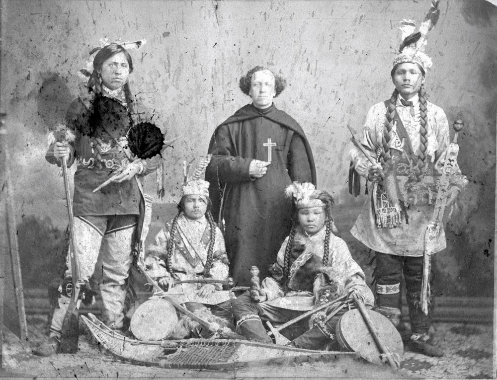 An undated photo from the Archdiocese of St. Paul and Minneapolis archives shows a Catholic missionary with Native American youth.