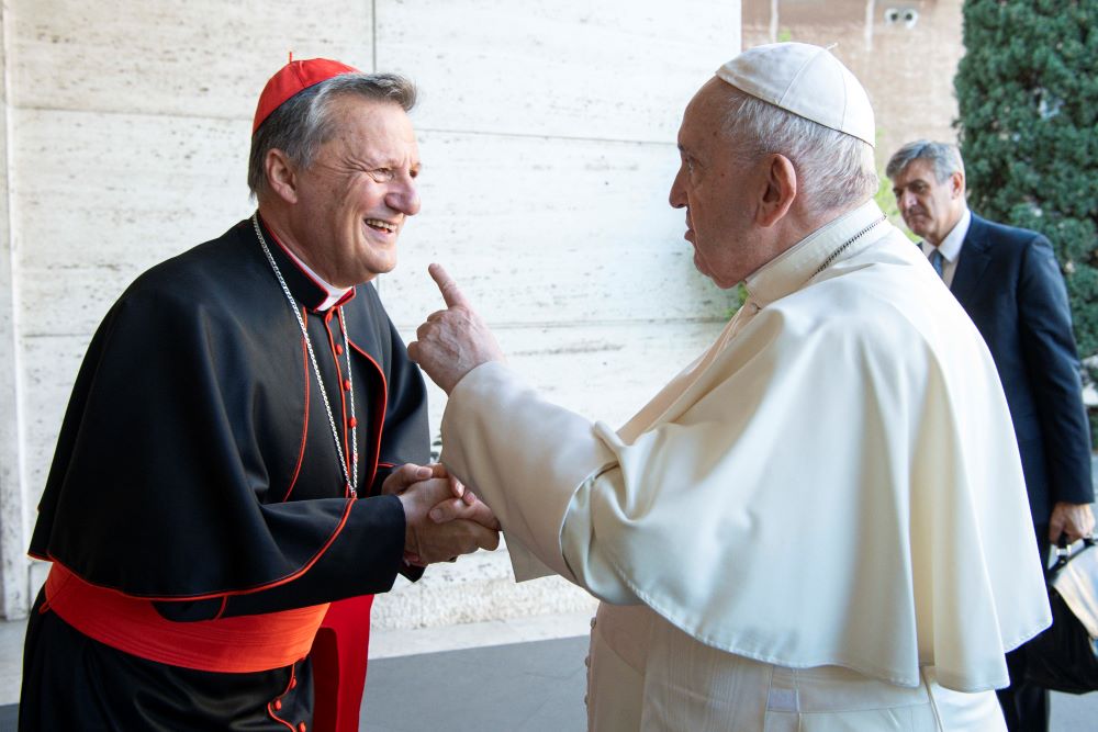 Cardinal Mario Grech greets Pope Francis.