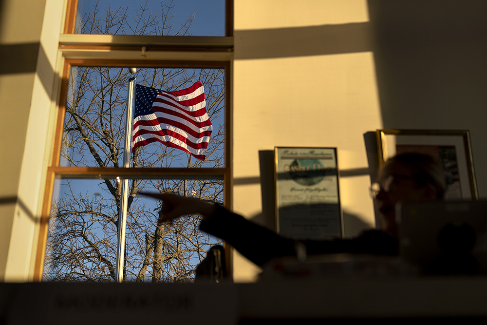 An American flag flies outside the Aspray Boat House polling site before the doors open to voters in the midterm election in Warwick, Rhode Island, Nov. 8, 2022. (AP/David Goldman)