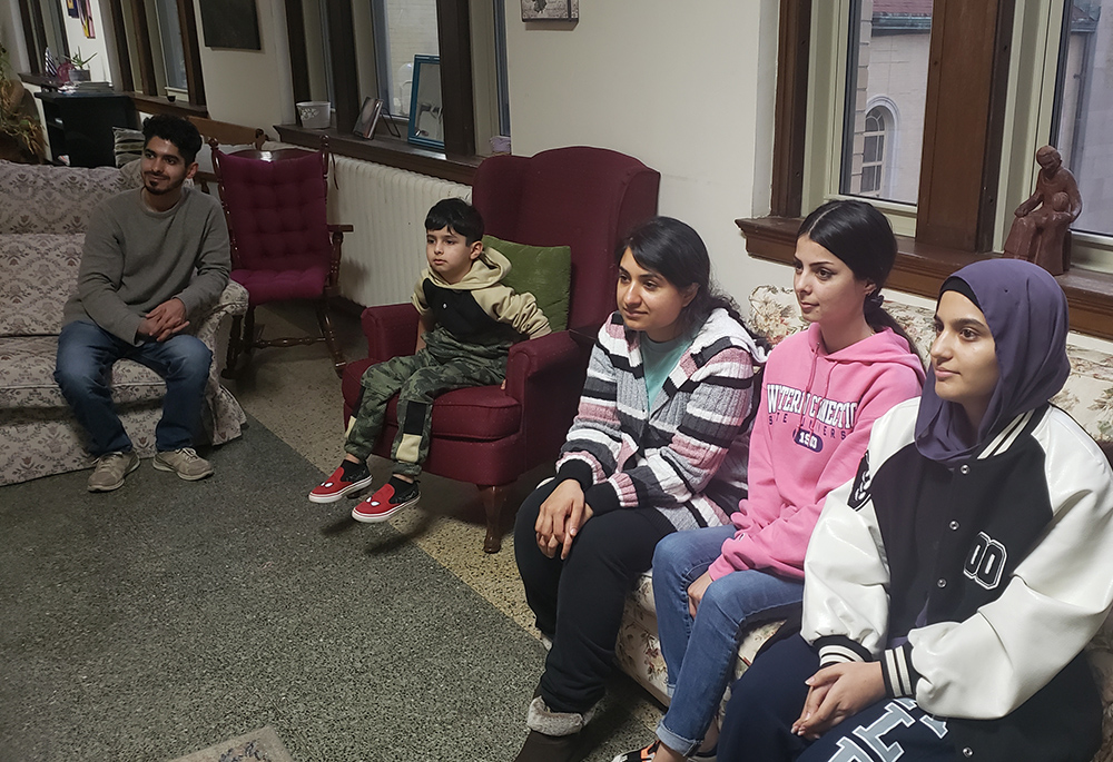 Recent refugees Hussain Shams, Omar Shams, Nadia Khan, Saliha Shams and Tamana Sayed watch TV at their residence on the campus of the Sisters of St. Joseph of Brentwood in Brentwood, Long Island, New York. The sisters are offering temporary housing to a number of refugees from at least three countries. Nadia Khan is from Pakistan; the others are from Afghanistan. (GSR photo/Chris Herlinger)