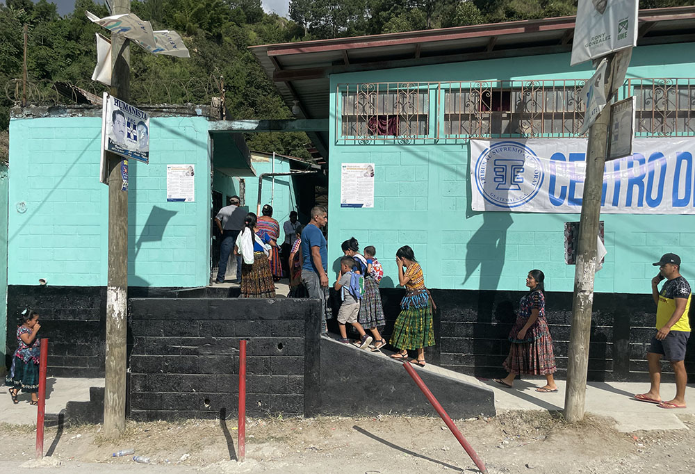 Families enter a voting center in Chinautla, on the edge of Guatemala City, in mid-August. (Courtesy of Faith in Action)