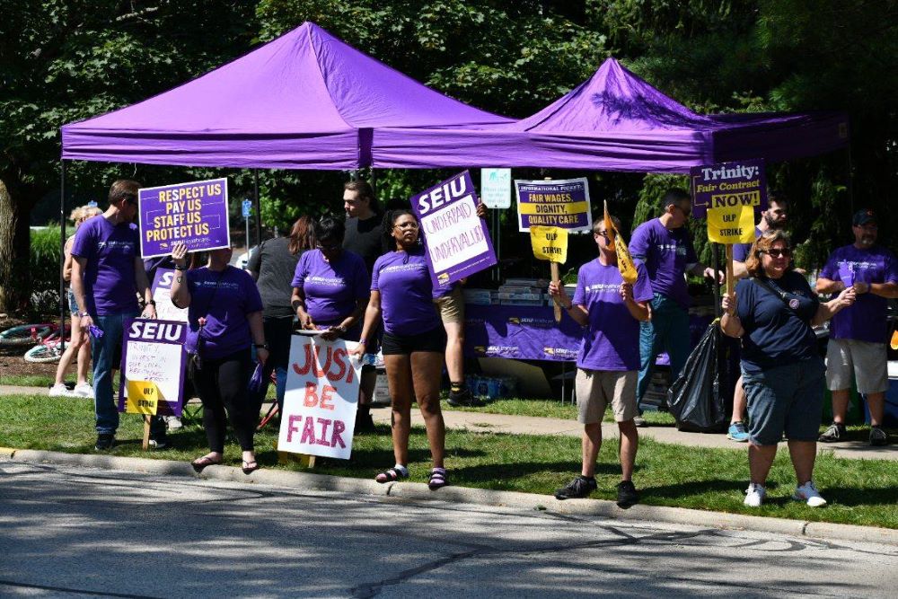 People wearing purple hold pro-union signs