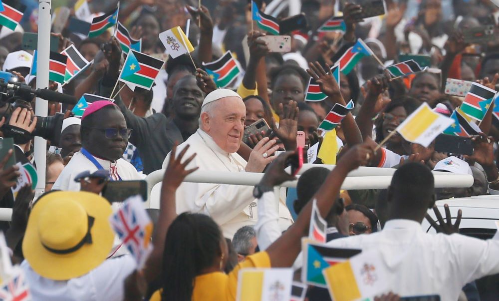 Pope Francis greets the crowd Feb. 5, 2023, as he arrives to celebrate Mass at the John Garang Mausoleum in Juba, South Sudan. 