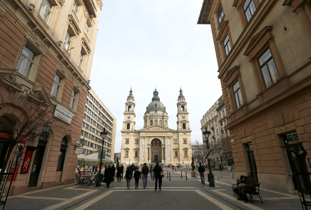 Pedestrians walk toward St. Stephen's Basilica in Budapest, Hungary.