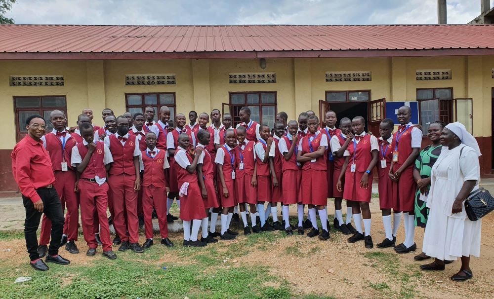 Sacred Heart Sr Mary Atimango, right, stands with students at one of the schools in Juba, South Sudan, where she teaches active nonviolence skills.(Courtesy of  Mary Atimango)