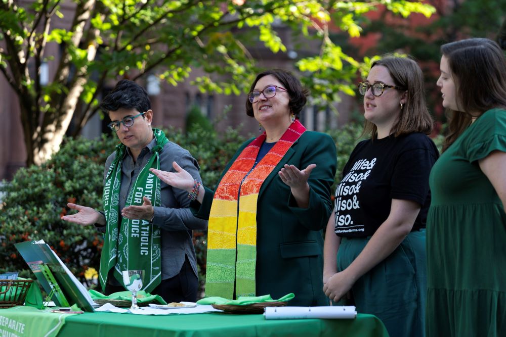 Angela Meyer, a Catholic woman priest (second from left), leads a Green Mass as Catholics for Choice protests the Supreme Court Red Mass outside St. Matthew's Cathedral in Washington, D.C., on Oct. 1. Jamie Manson, president of Catholics for Choice, is at left. (AP Photo/Jose Luis Magana)