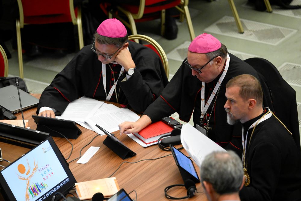 Members of the assembly of the Synod of Bishops use tablets to vote on the gathering's synthesis document Oct. 28 in the Paul VI Hall at the Vatican. (CNS/Vatican Media)
