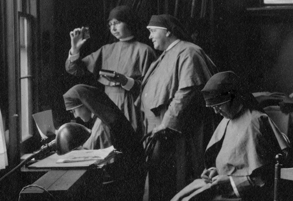 Mother Mary Joseph Rogers, foundress of the Maryknoll Sisters, center right, visits with other Maryknoll sisters in 1925 at work in their art room. (CNS/Courtesy of Maryknoll Mission Archives)
