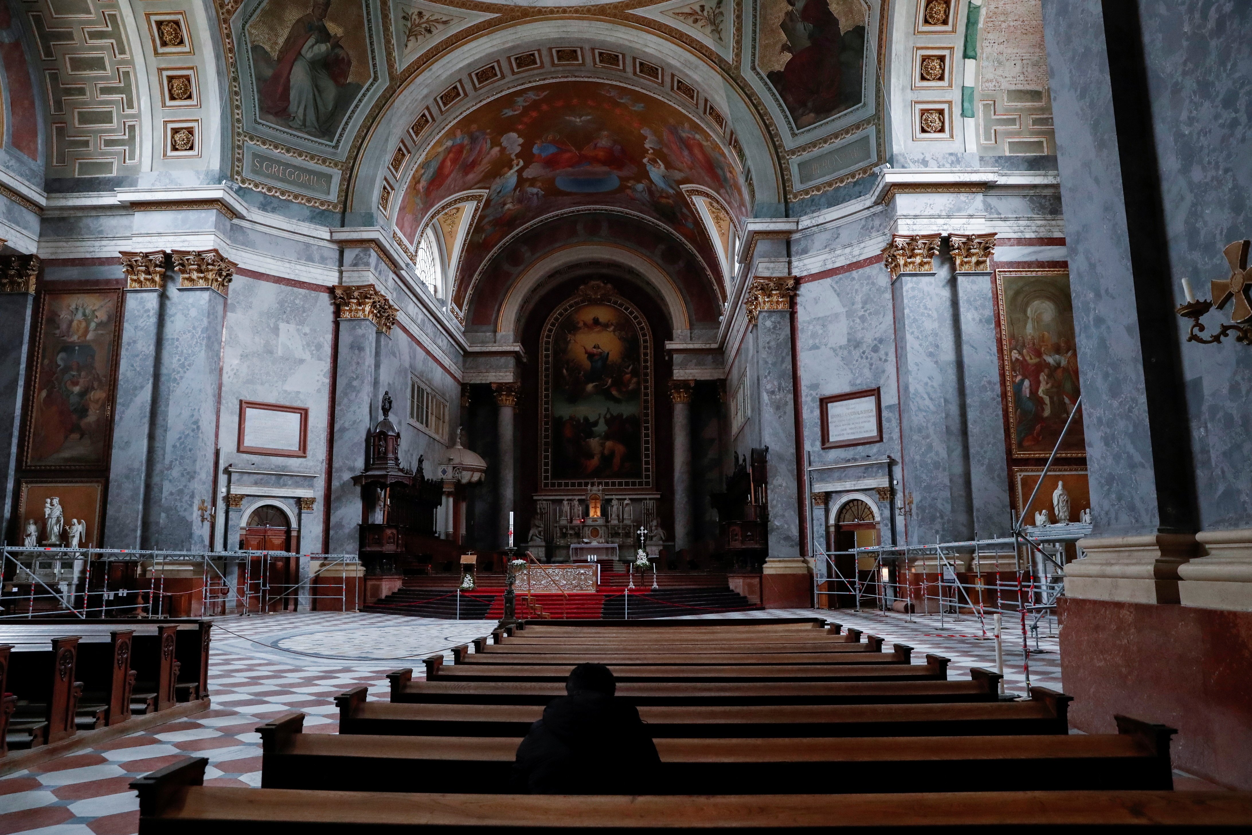 A person prays inside the Catholic basilica in Esztergom, Hungary, April 14, 2021.