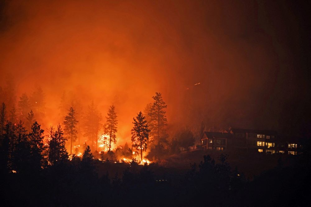 The McDougall Creek wildfire burns near homes outside the Okanagan community of West Kelowna, British Columbia, Aug. 18, 2023. (OSV News/Reuters/Chris Helgren)