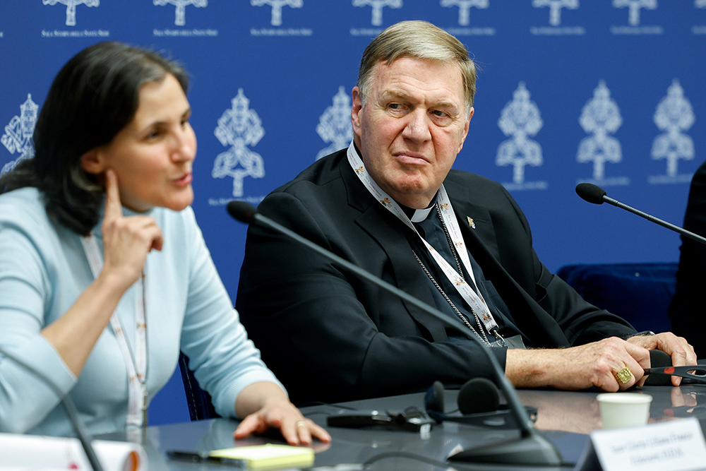 Cardinal Joseph Tobin of Newark, New Jersey, listens to Sr. Liliana Franco Echeverri, a member of the Company of Mary and president of the Latin American Confederation of Religious, as she speaks during a briefing about the assembly of the Synod of Bishops at the Vatican Oct. 10. (CNS/Lola Gomez)