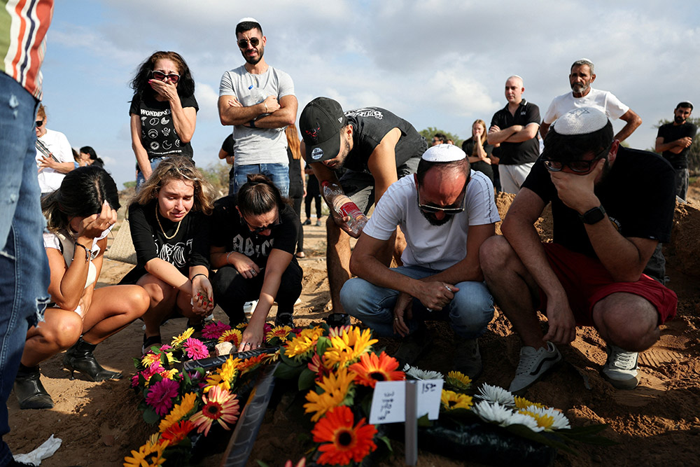 People mourn at the graveside of Eden Guez during her funeral in Ashkelon, Israel, Oct. 10. She was killed while attending a festival that was attacked by Hamas gunmen from Gaza. (OSV News/Reuters/Violeta Santos Moura)