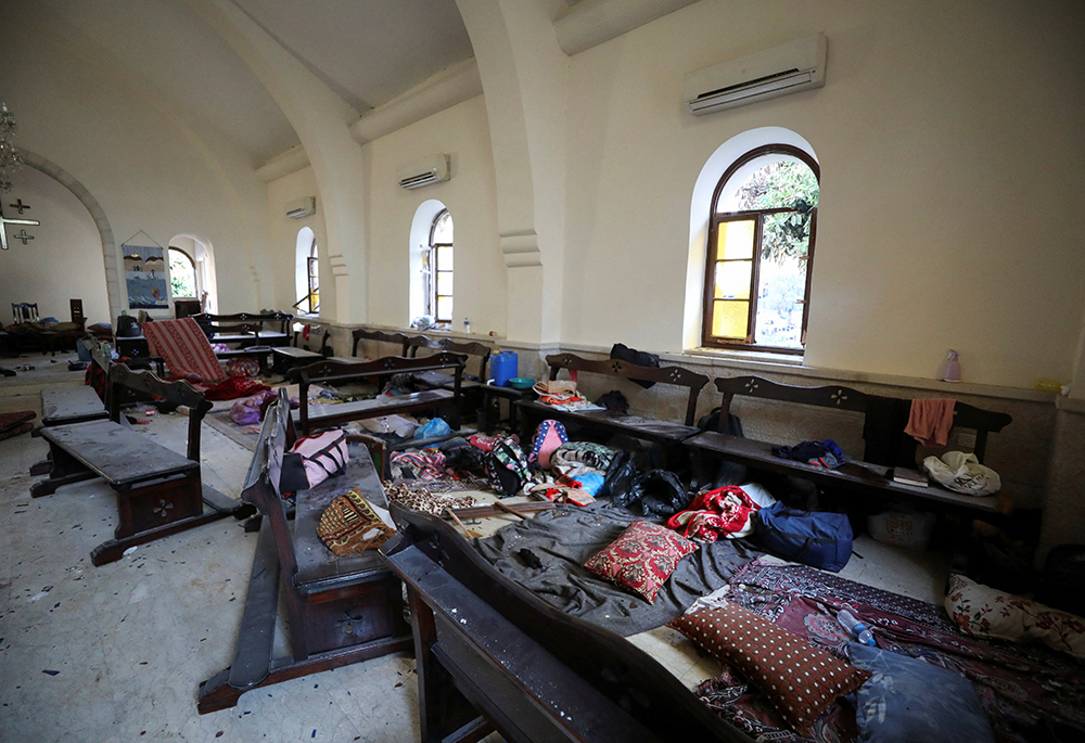 Personal items litter the pews inside a damaged church Oct. 18, located within the premises of the CNEWA-supported al-Ahli Arab Hospital in Gaza City, following a deadly explosion the previous day where hundreds of people were likely killed. (OSV News/Reuters/Mohammed Al-Masri)