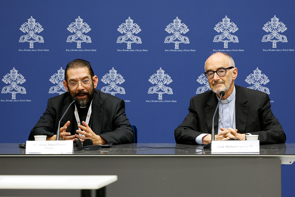 Bishop Daniel Flores of Brownsville, Texas, speaks during a briefing about the assembly of the Synod of Bishops as Cardinal Michael Czerny, prefect of the Dicastery for Promoting Integral Human Development, listens at the Vatican Oct. 19. (CNS/Lola Gomez)