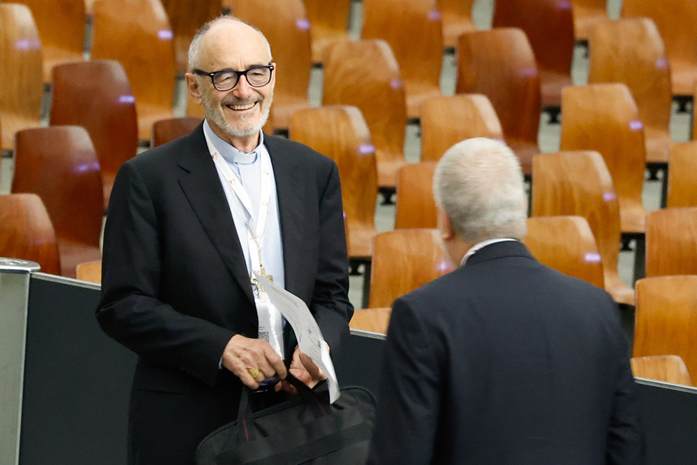 Cardinal Michael Czerny, prefect of the Dicastery for Promoting Integral Human Development, arrives in the Vatican's Paul VI Audience Hall for a working session of the assembly of the Synod of Bishops Oct. 20. (CNS/Lola Gomez)