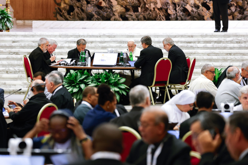 Pope Francis joins leaders and members of the assembly of the Synod of Bishops for a working session in the Vatican's Paul VI Audience Hall Oct. 23, 2023. (CNS photo/Lola Gomez)