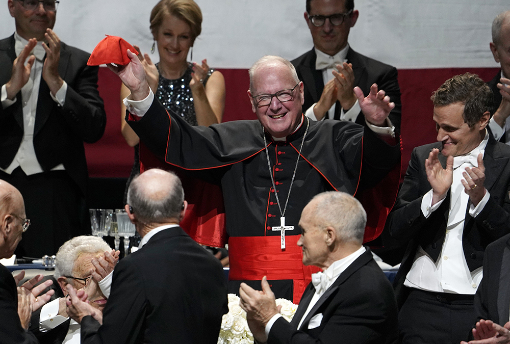 New York Cardinal Timothy Dolan waves to the audience after being introduced at the 78th annual Alfred E. Smith Memorial Foundation Dinner at the Park Avenue Armory Oct. 19 in New York City. (OSV News/Gregory A. Shemitz)
