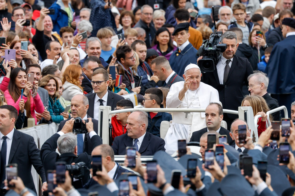 Pope Francis greets visitors from the popemobile as he rides around St. Peter's Square at the Vatican before his weekly general audience Oct. 25, 2023. (CNS photo/Lola Gomez)