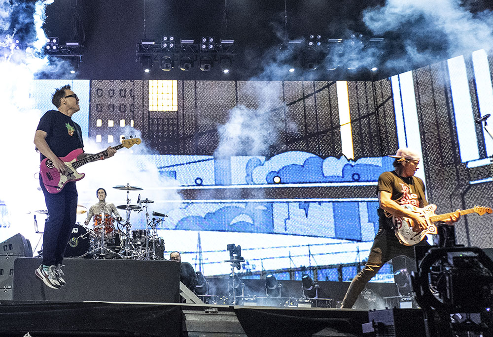 From left, Mark Hoppus, Travis Barker and Tom DeLonge of Blink-182 perform at the Coachella Music and Arts Festival at the Empire Polo Club April 24 in Indio, California. (AP/Invision/Amy Harris)
