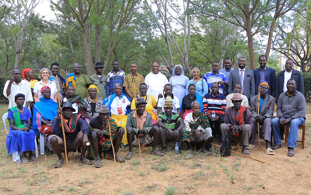 Africa Faith and Justice Network members pose Sept. 27 with traditional leaders who participated in a three-day enlightenment program on child trafficking in Karamoja, Uganda. (Courtesy of Eucharia Madueke)