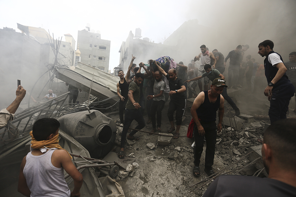 Palestinians remove a dead body from the rubble of a building after an Israeli airstrike Jebaliya refugee camp, Gaza Strip, Oct. 9. (AP/Ramez Mahmoud )